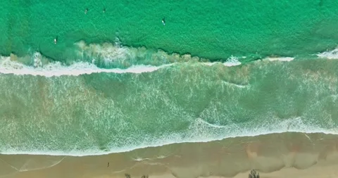 Aerial top view white waves in green sea loop on the white sand beach. Stock Footage 242079491