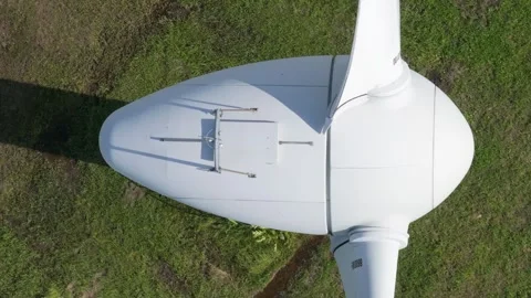 Aerial top view of a white wind turbine nacelle generating Stock Footage 344277461