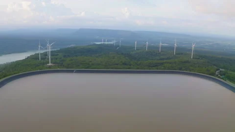Aerial top view of wind turbines or windmills farm field with water in lake o Stock Footage