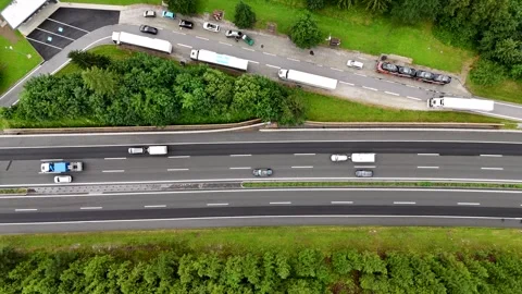 Aerial top view of a winding mountain road surrounded by deep forest Stock Footage 322045404
