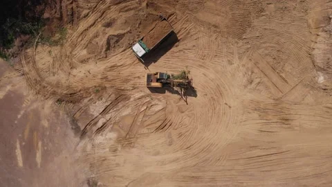 Aerial top view: yellow excavator moving broken tree. Stock Footage 133109341