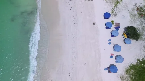 Aerial TopDown Blue Umbrellas Aligned On White Sand Vídeo Stock 329586652