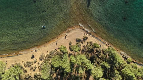 Aerial topdown forest to emerald clear water Lake Tahoe summer US LKT 0013 A GR Video stock 143307277