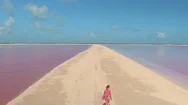 Aerial: Tourist Girl Strolling Along The Gorgeous Pink Lakes In Sunny Mexico Stock Footage
