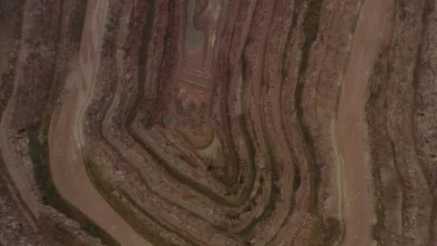Aerial tow down view fly over deep quarry earth ground layers and gravel road Vídeos de archivo 251044335