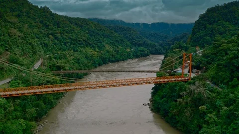 Aerial towards two suspension bridges above river in Amazon rainforest 스톡 동영상 115841853