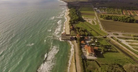 Aerial, a tower of a coastal fortification on the empty beach Video stock 83321562