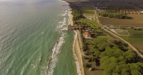 Aerial, a tower of a coastal fortification on the empty beach Stock Footage 84165514