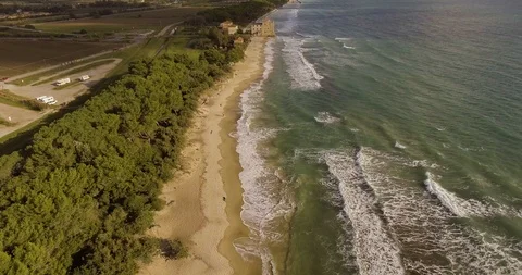 Aerial, a tower of a coastal fortification on the empty beach Stock-Footage 85560886
