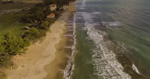 Aerial, a tower of a coastal fortification on the empty beach Vídeo Stock 86739218