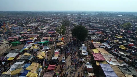 Aerial track view of a huge crowd moving on busy roads amidst a crowded fair Stock-Footage 233076632