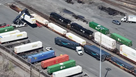 Aerial track view of intermodal rail yard with Amazon Prime trailer truck Vídeo Stock 344597038