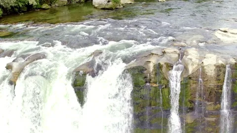 Aerial tracking back to reveal a large waterfall Stock Footage 155466484