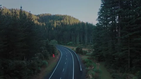Aerial tracking as a car drives down a country road Video stock 153875288