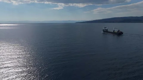 Aerial tracking of cargo ship and its wake Stock Footage 335646065