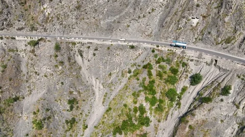 Aerial tracking of cargo trucks and oil tanker on steep Dangerous Himalayan.. Stock-Footage 337615209