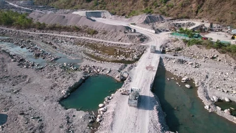 Aerial tracking of dump trucks transporting construction material Vídeos de archivo 334116828