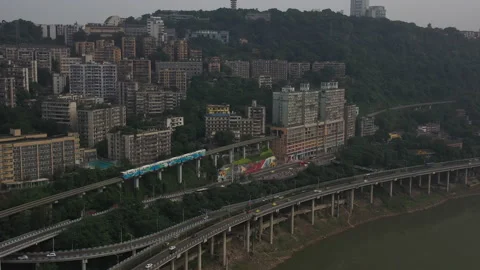 Aerial Tracking Elevated Train Entering Apartment Block in Chongqing Stock Footage 205089938