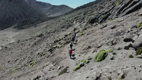 Aerial tracking of a group on an expedition in the middle of the mountains Video stock 202347689