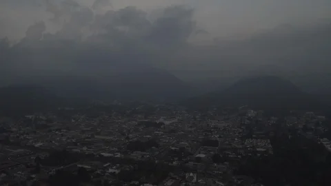 Aerial tracking high to low of dark and cloudy Antigua Guatemala Video stock 110890741