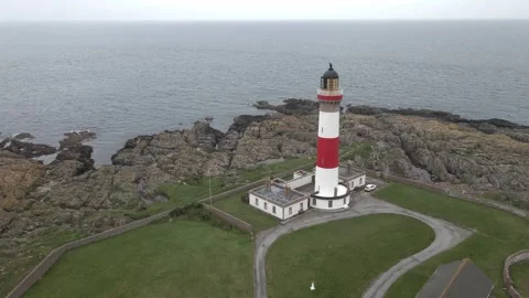 Aerial tracking over Buchan Ness Lighthouse at Boddam near Peterhead, Scotland Stock Footage 341357563