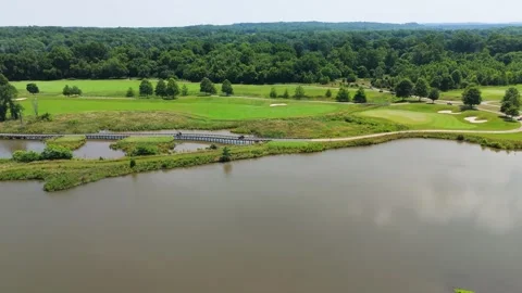 Aerial Tracking Over Golf Course Pond and Wooden Bridge Stock Footage 346188800