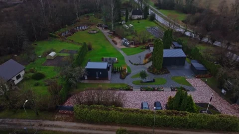 Aerial tracking of private property with brick driveways and outbuildings Video stock 324796904