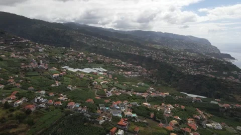 Aerial tracking shot along the hillside terraces of Ponta do Sol’s Canhas Stock Footage 345642948
