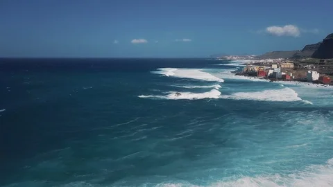 Aerial tracking shot backward over a costal Spanish town in Canary Islands 4K Video stock 101565509