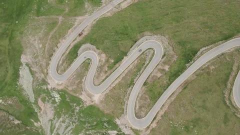 Aerial tracking shot of a car driving on the Transalpina road 動画素材 340647580
