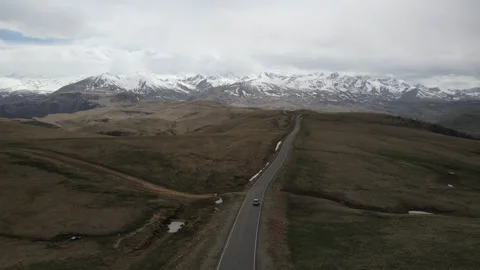 Aerial tracking shot of a car on a mountain road Stock Footage 337023651