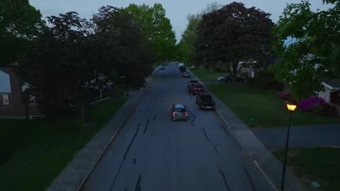Aerial tracking shot of car van driving through residential suburban home 動画素材 241382982