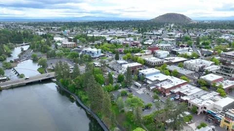 Aerial Tracking Shot of Downtown Bend Oregon with Deschutes River and Greenery Stock Footage 280142791