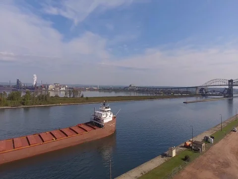 Aerial tracking shot of freighter on St Marys River Stock Footage 80896167