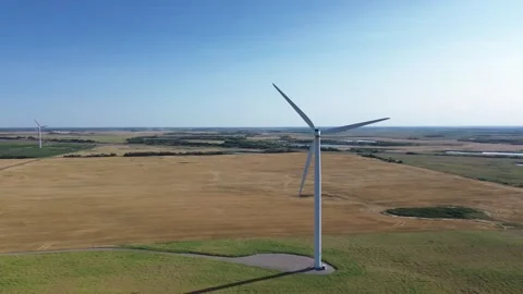 Aerial tracking shot of a modern wind turbine with a cinematic sun flare. Stock Footage 316638646