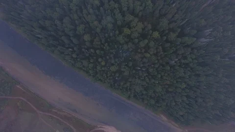 Aerial tracking shot of mountain river flowing between the mountains covered Stock Footage 87035189