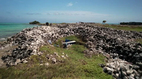 Aerial Tracking Shot Over Giant Seashell Mounds on Tropical Caribbean Island Vídeo Stock 339102498