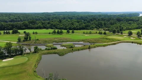 Aerial Tracking Shot Over Golf Course Water Hazard and Bridge Stock Footage 346188771