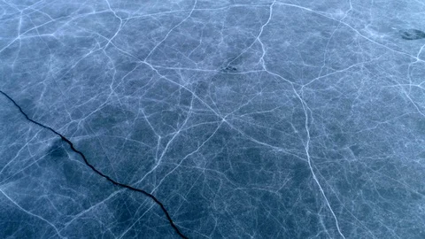 Aerial Tracking Shot Over Lake Ice Pattern Stock Footage