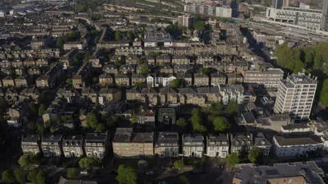 Aerial tracking shot past rows of sunlit Victorian residential houses in Stock Footage 284246871