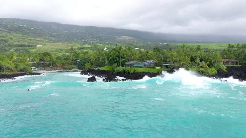 Aerial Tracking Shot of Powerful Waves Crashing on Volcanic Coast by Luxury Stock Footage 328388178