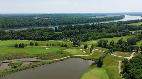 Aerial Tracking Shot of Riverfront Golf Course on a Clear Day Stock Footage 346188788