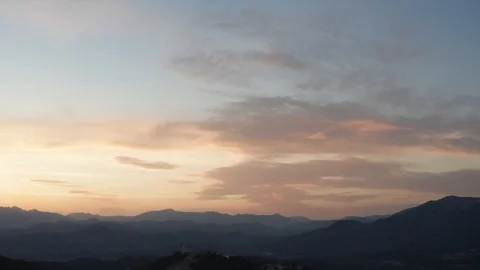 An aerial tracking shot of sunset between the mountains Stock-Footage 114742548