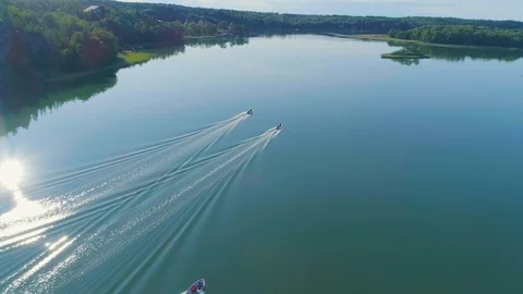 Aerial tracking shot of three small boats on a picturesque day at sea Stock Footage 100550370
