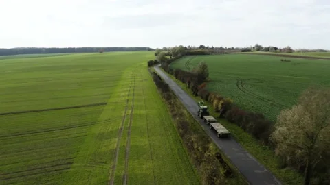 Aerial tracking shot of a tractor along northern German fields Stock Footage