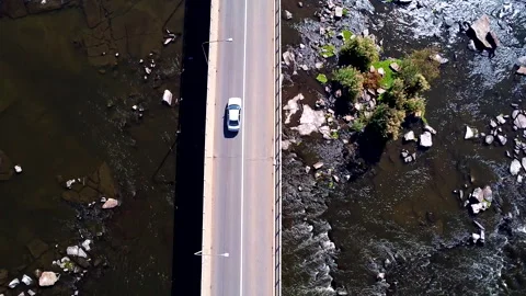 An aerial tracking shot of a vehicle driving over a bridge Stock Footage 288206341