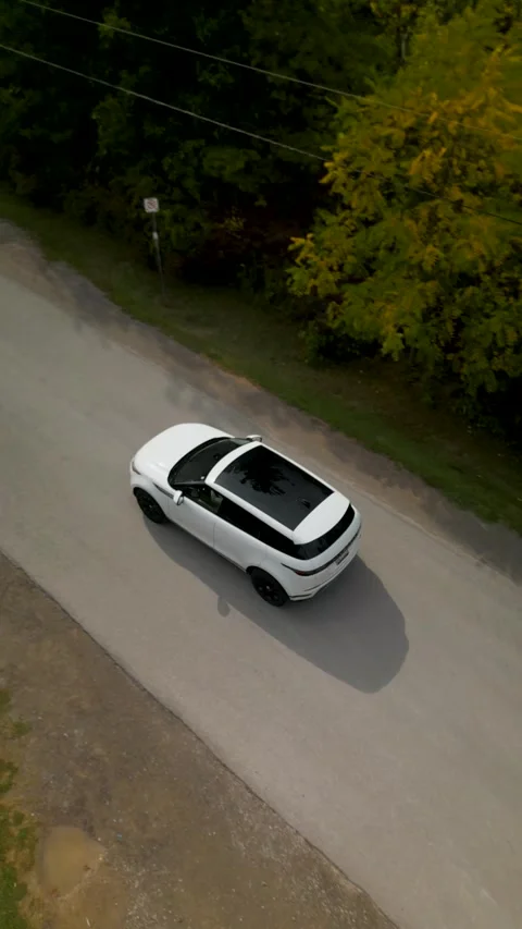 Aerial tracking shot of a white SUV driving on a rural road in Ontario, Canada Video stock 317790877