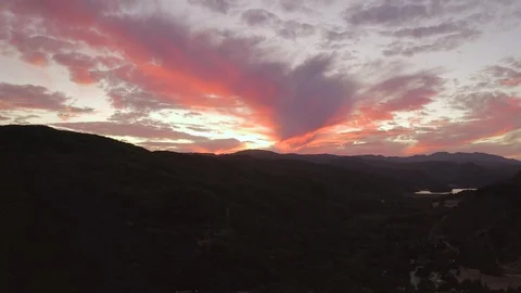 Aerial tracking sunset shot deep red towards lake Stock Footage 127119482