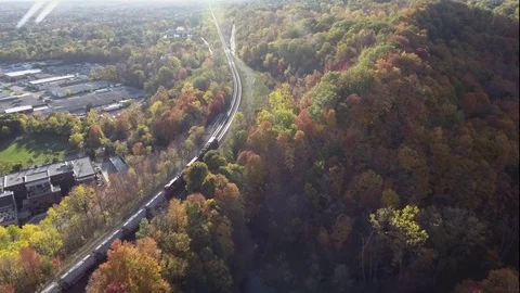 Aerial tracking of a Train in the Fall Stock Footage 77550624