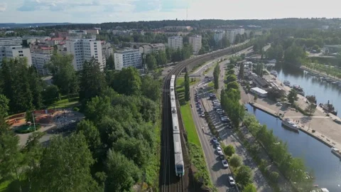 Aerial tracking video of a moving train in Finland Stock Footage 247269143